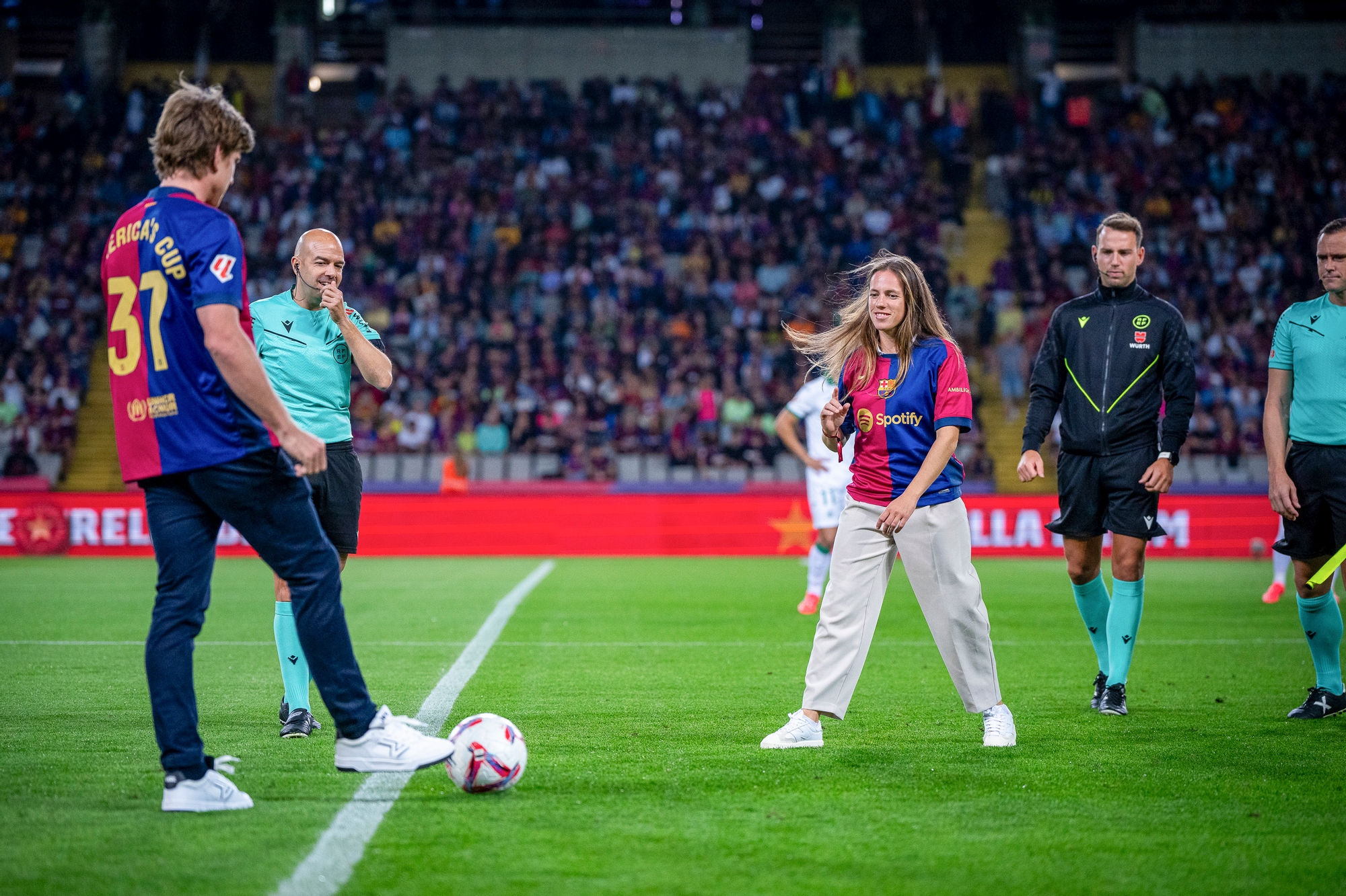September 25, 2024.Emirates Team New Zealand Skipper Peter Burling and Silvia Mas from Sail Team BCN Women, at the Futbol Club Barcelona match in Estadi Olimpic Barcelona.